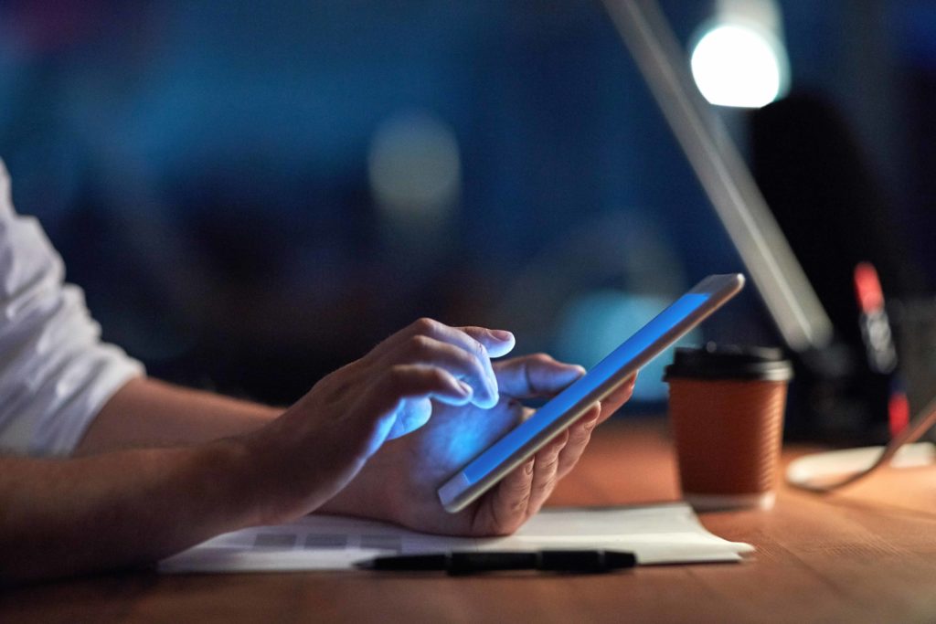 man on phone in office evoking Bring Your Own Device Guidelines