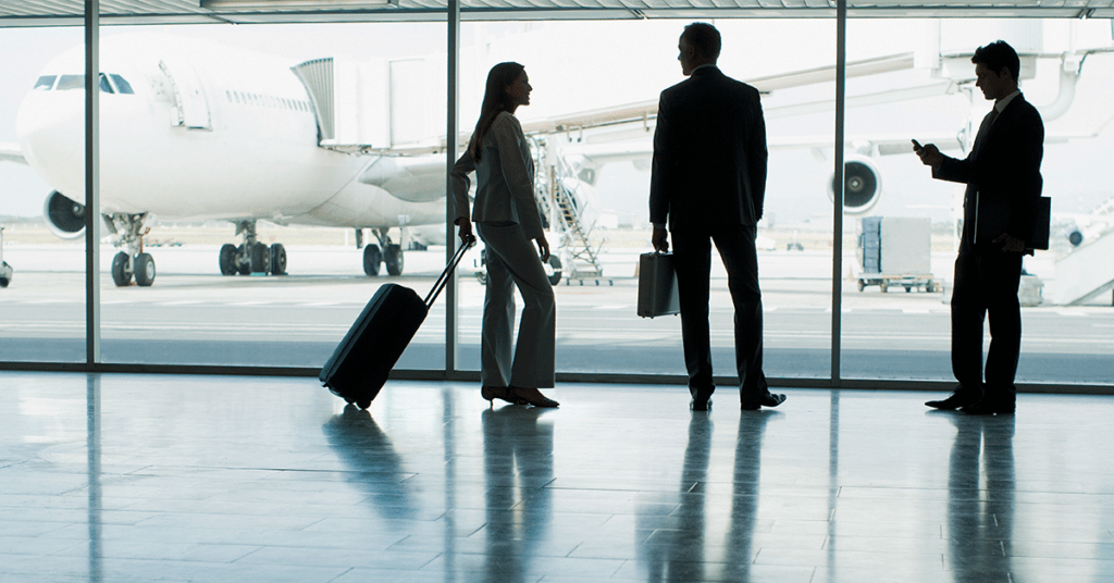 group of business travelers in airport evoking corporate travel