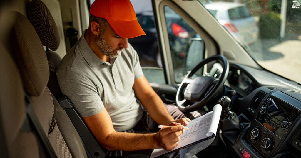 man with notepad in van evoking reimbursing temporary drivers