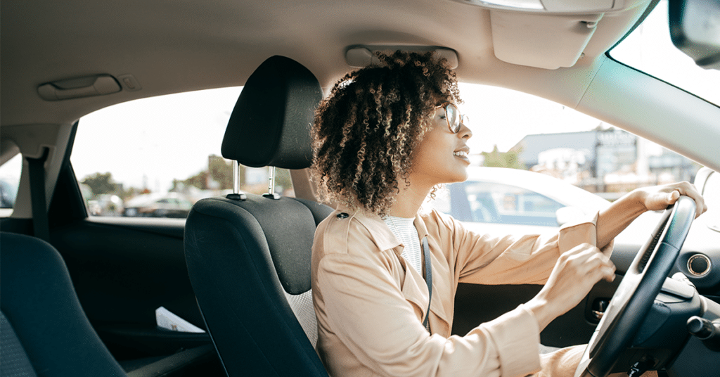 woman in car exhibiting good driving best practices