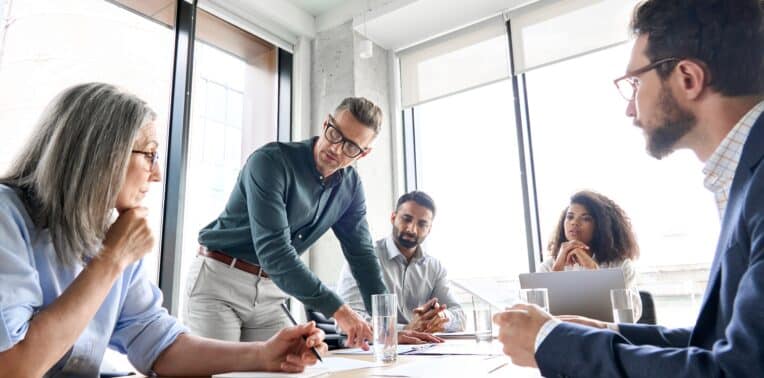 Image of a group of employees talking to each other